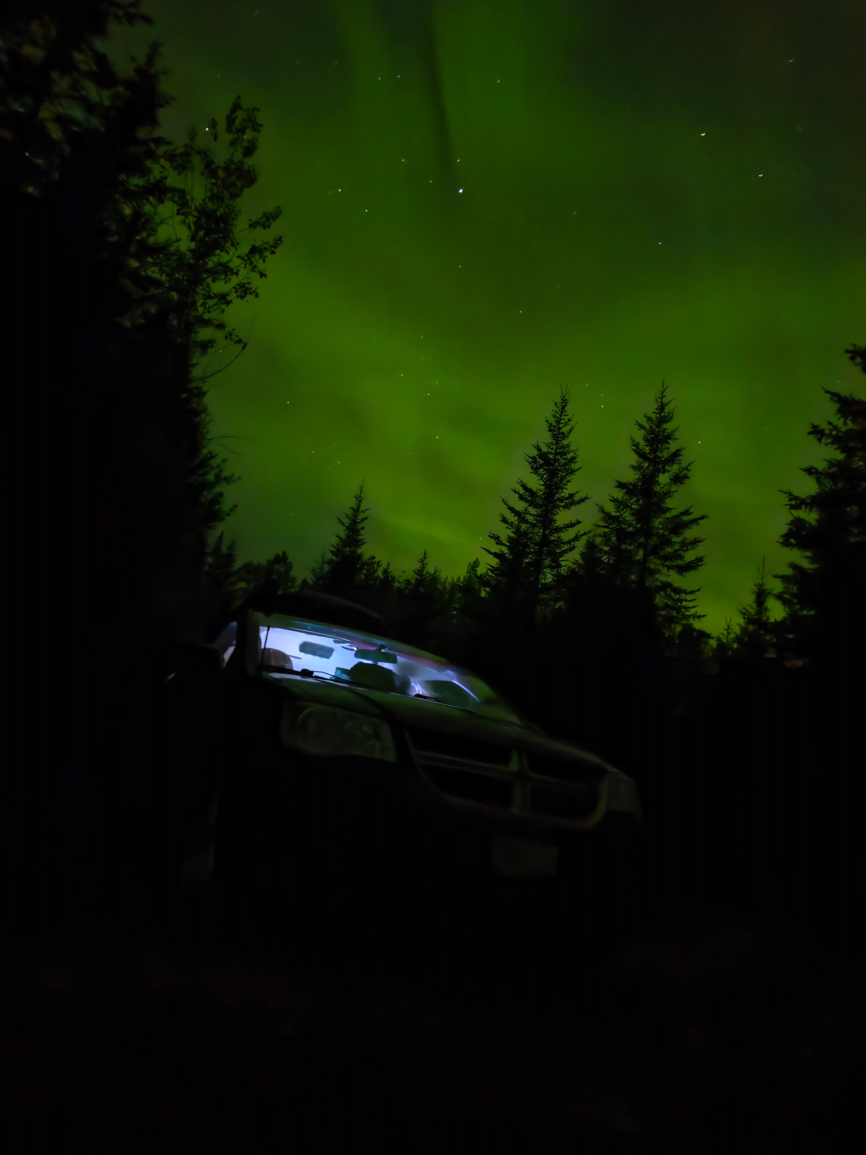 Green aurora borealis over the van at night
